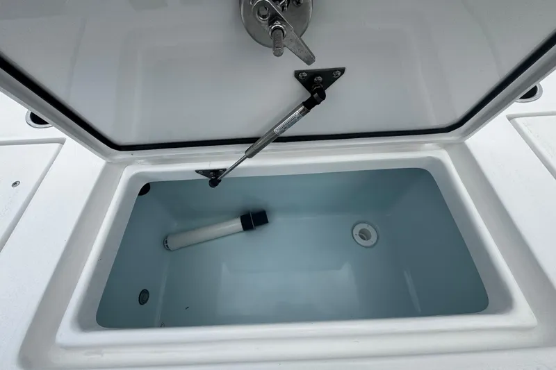 Slide: The Image of Open storage compartment in 2026 Piranha Casador B2200 boat, featuring a hydraulic lift. - 16