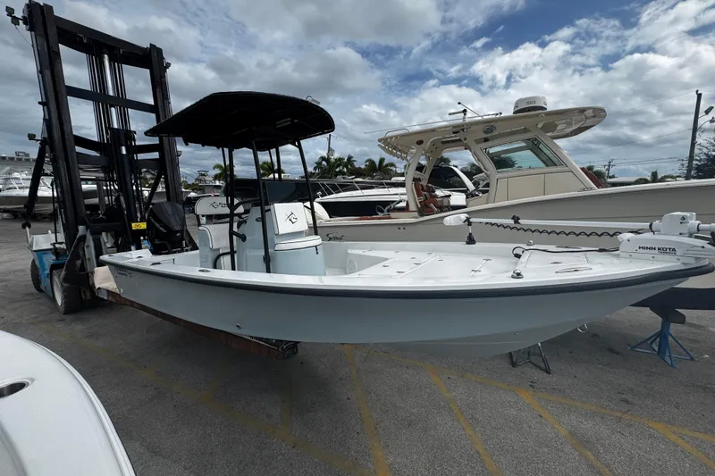 Slide: The Image of 2026 Piranha Casador B2200 boat on forklift, marina background, cloudy sky. - 2
