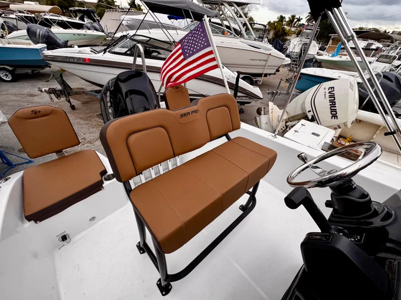 Slide: The Image of 2025 Sea Pro 202 Center Console boat with tan seating and American flag. - 11