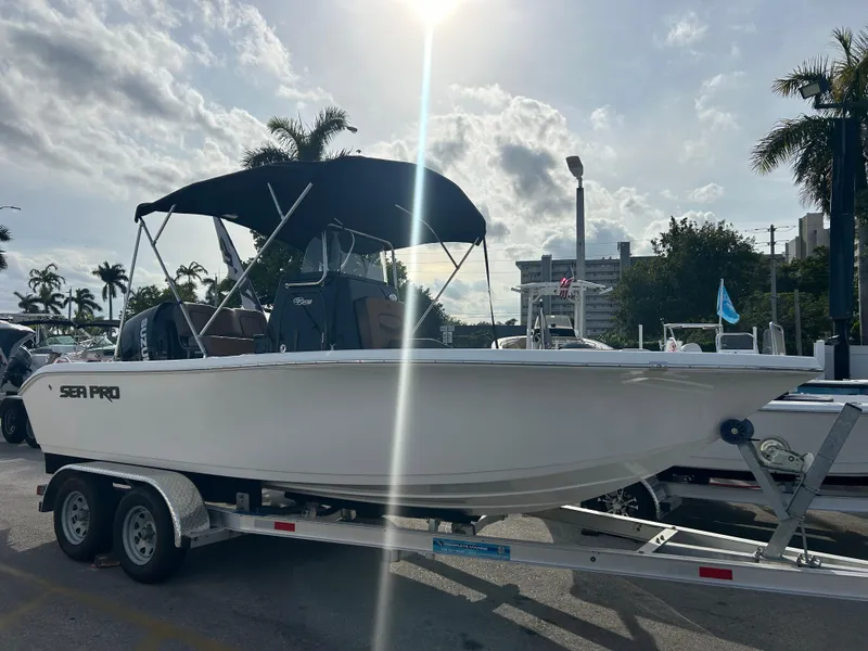 Slide: The Image of 2025 Sea Pro 202 Center Console boat on trailer under sunny sky. - 2