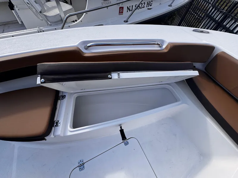 Slide: The Image of 2025 Sea Pro 202 Center Console boat with open storage compartment and cushioned seating. - 20