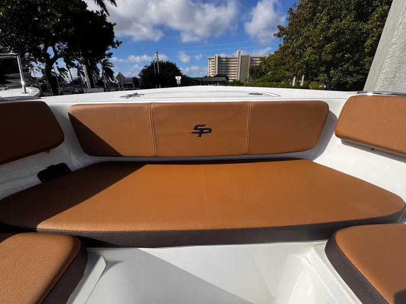 Slide: The Image of 2025 Sea Pro 202 Center Console boat with brown seating, outdoor view. - 21