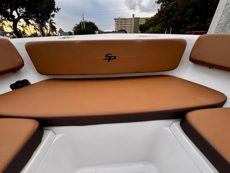 Slide: The Image of 2025 Sea Pro 202 Center Console boat with brown cushioned seating. - 24