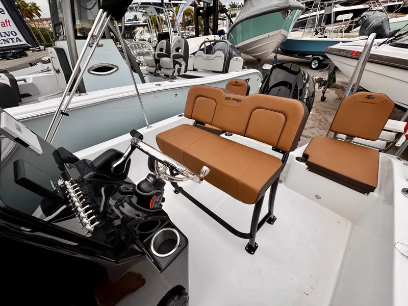 Slide: The Image of 2025 Sea Pro 202 Center Console boat interior with tan seating and control panel. - 5