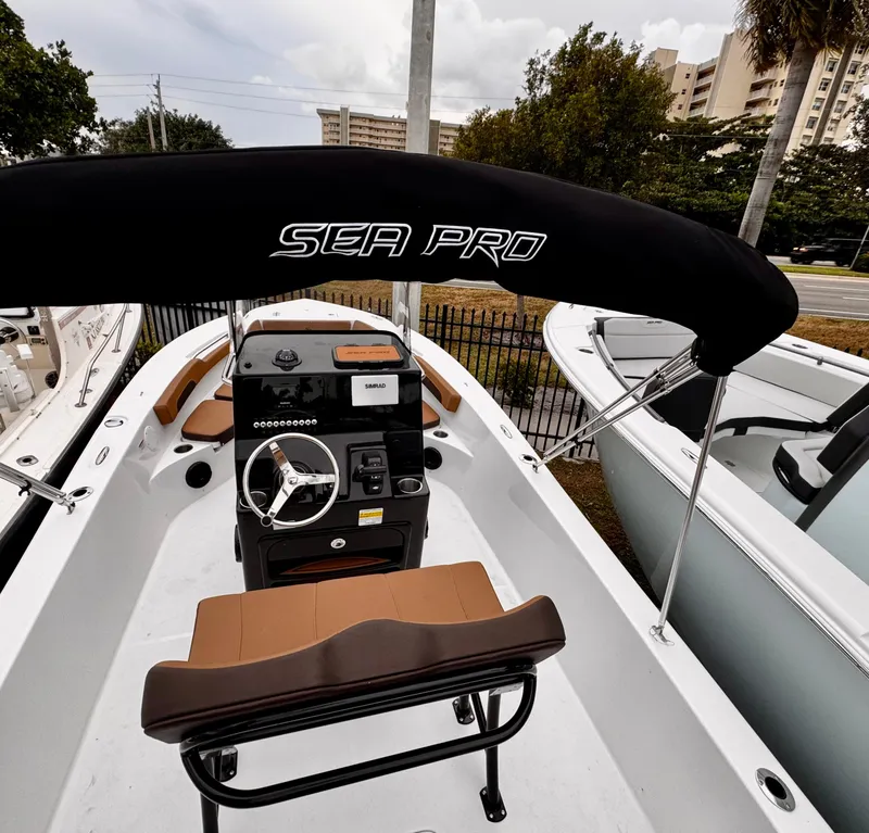 Slide: The Image of 2025 Sea Pro 202 Center Console boat with black canopy and modern dashboard. - 7