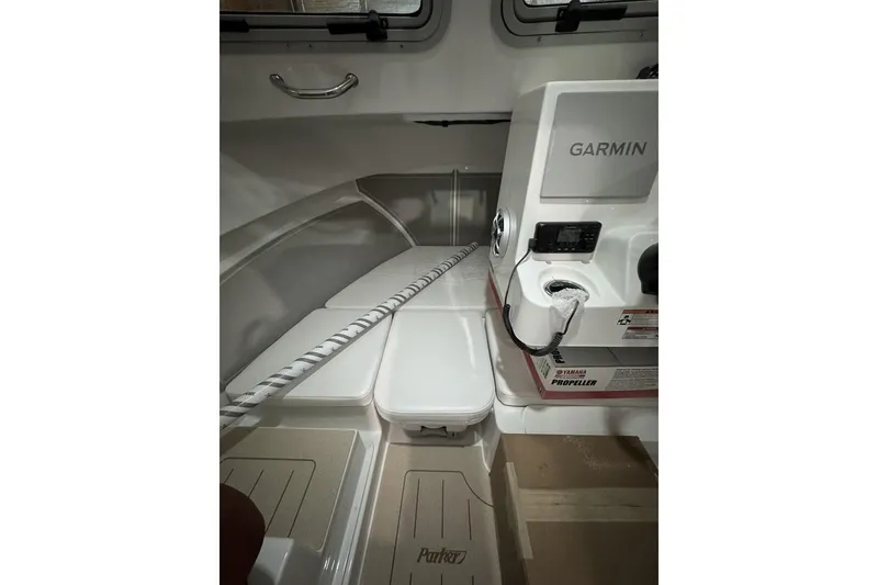Slide: The Image of Interior of 2025 Parker 2420 Sport Cabin with Garmin equipment and Yamaha propeller controls. - 10