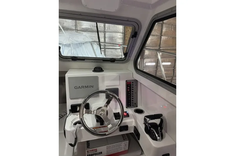 Slide: The Image of Interior of 2025 Parker 2420 Sport Cabin with Garmin navigation system and steering wheel. - 12
