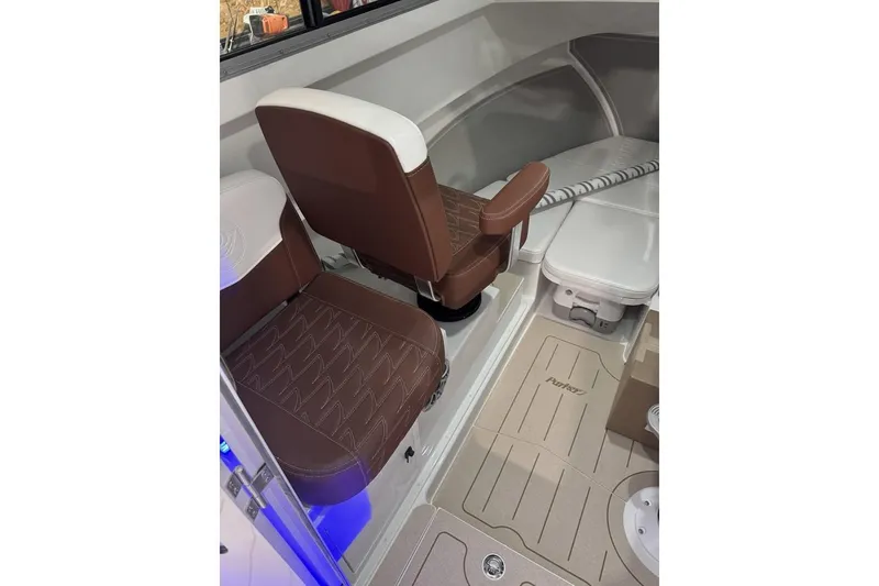 Slide: The Image of Interior of 2025 Parker 2420 Sport Cabin boat with brown seating and modern design. - 14