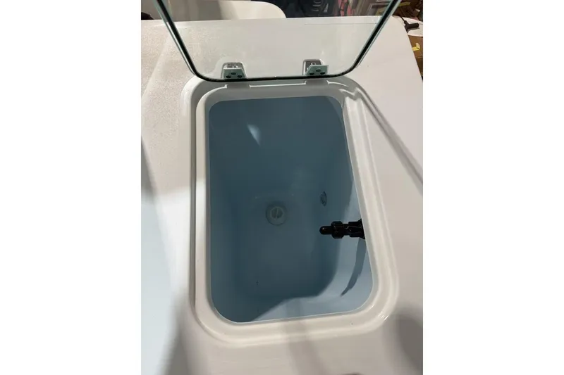 Slide: The Image of Livewell compartment in 2025 Parker 2420 Sport Cabin boat, open lid view. - 17