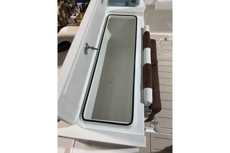 Slide: The Image of 2025 Parker 2420 Sport Cabin boat storage compartment with cushioned seating. - 18