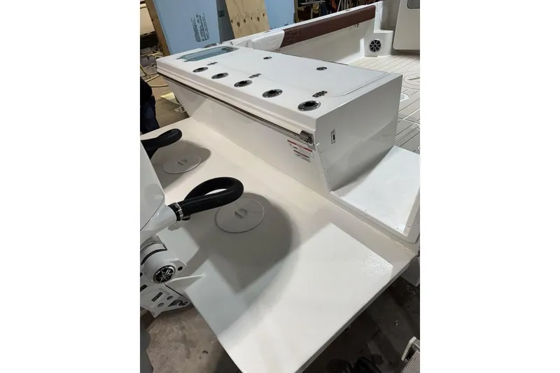 Slide: The Image of 2025 Parker 2420 Sport Cabin boat interior with seating and storage compartments. - 21