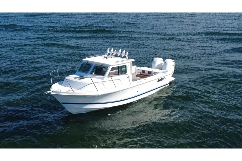 Slide: The Image of 2025 Parker 2420 Sport Cabin boat cruising on open water. - 6