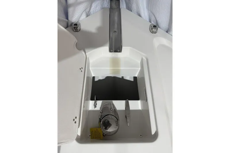 Slide: The Image of 2025 Parker 2420 Sport Cabin boat anchor compartment with open hatch and winch. - 7