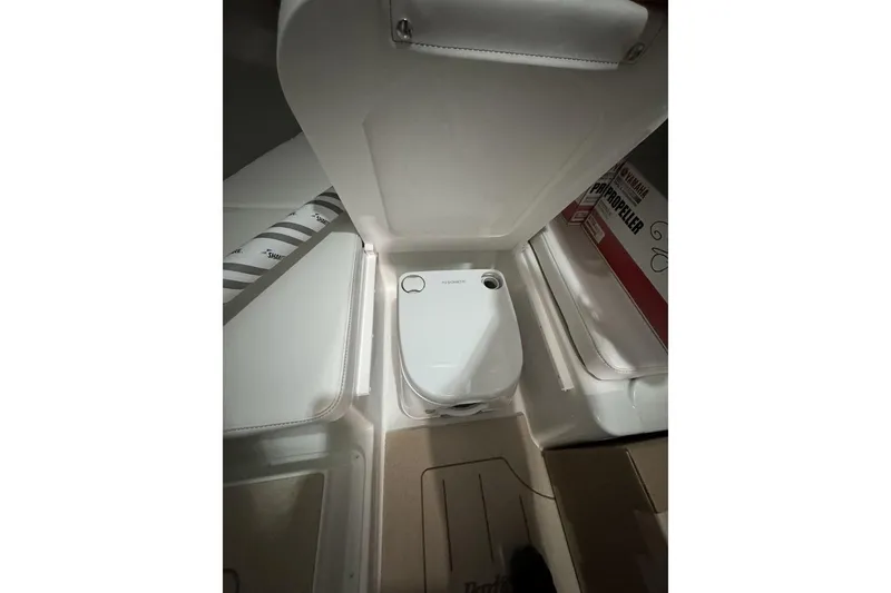 Slide: The Image of Interior of 2025 Parker 2420 Sport Cabin boat showing compact toilet setup. - 9