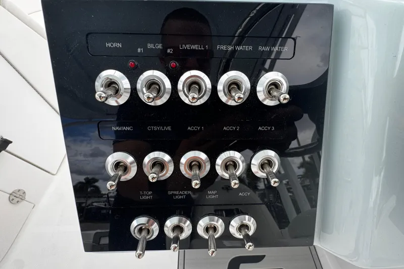 Slide: The Image of Control panel of 2026 Sea Pro 240 Dual Console boat with multiple toggle switches. - 10