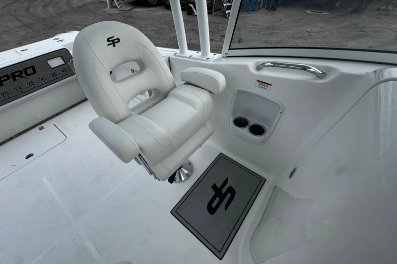 Slide: The Image of 2026 Sea Pro 240 Dual Console boat interior with white seating and cup holders. - 12
