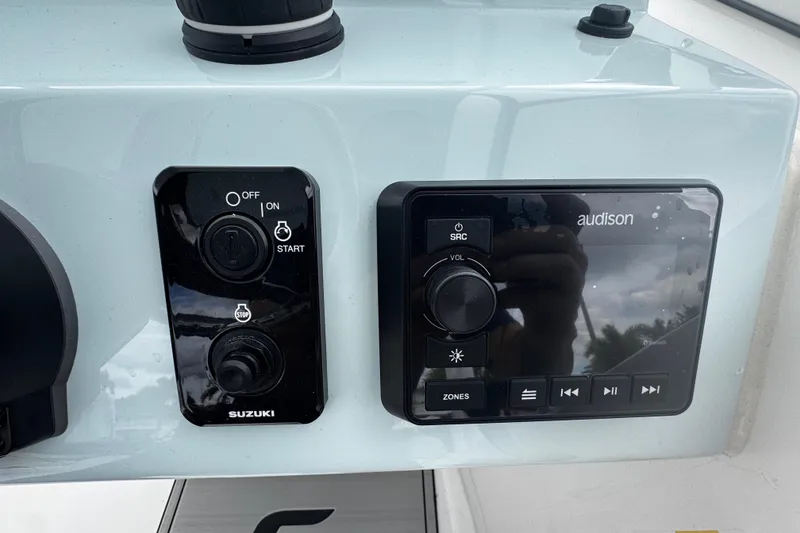 Slide: The Image of 2026 Sea Pro 240 Dual Console dashboard with Suzuki ignition and Audison audio controls. - 15