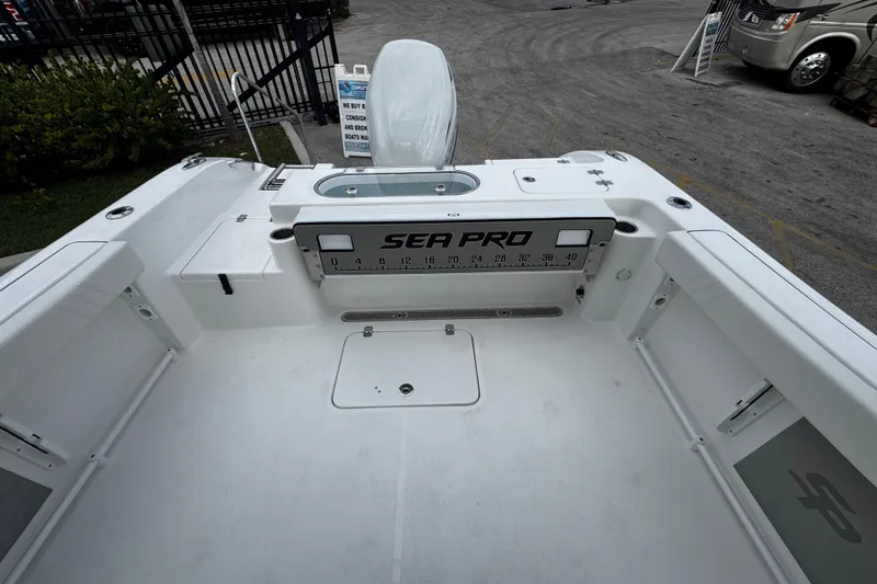 Slide: The Image of 2026 Sea Pro 240 Dual Console boat interior with spacious deck and storage compartments. - 16