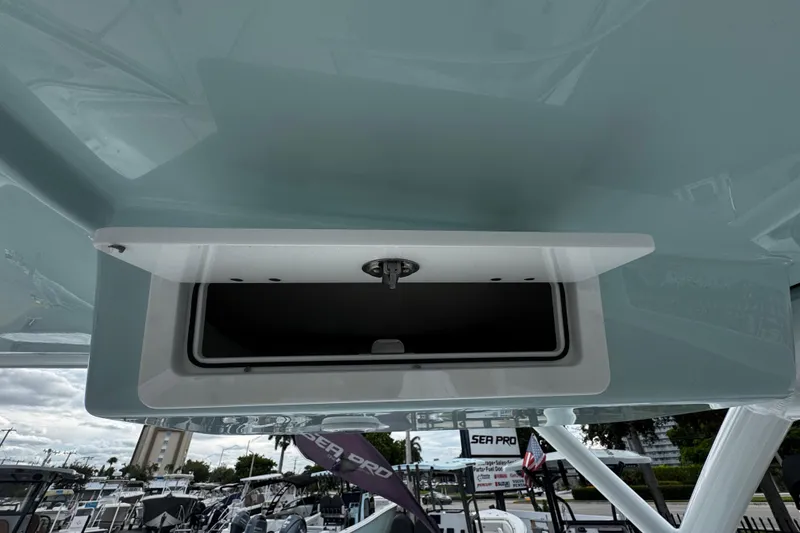 Slide: The Image of 2026 Sea Pro 240 Dual Console boat storage compartment, open view. - 18