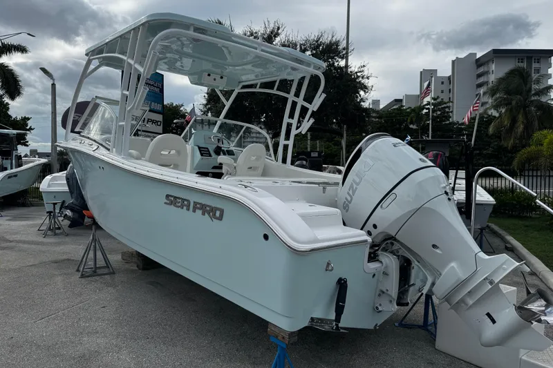 Slide: The Image of 2026 Sea Pro 240 Dual Console boat with Suzuki outboard motor on display. - 2