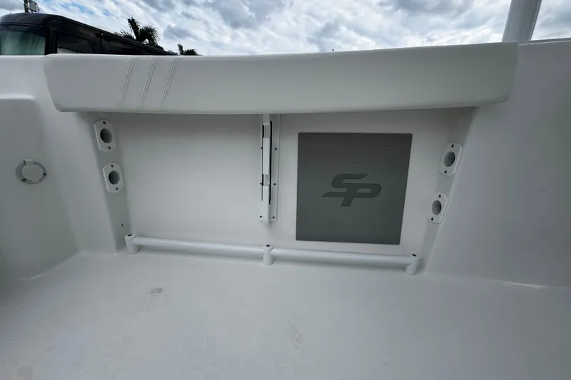 Slide: The Image of 2026 Sea Pro 240 Dual Console boat interior with storage compartment and logo. - 21