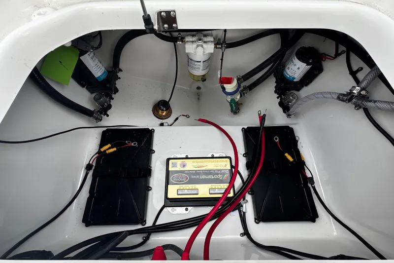 Slide: The Image of 2026 Sea Pro 240 Dual Console boat battery compartment with wiring and components. - 23