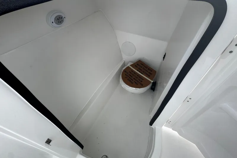 Slide: The Image of 2026 Sea Pro 240 Dual Console boat interior with compact marine toilet. - 7