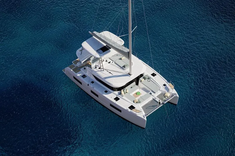 Slide: The Image of 2026 Lagoon 47 catamaran on calm blue waters. - 4