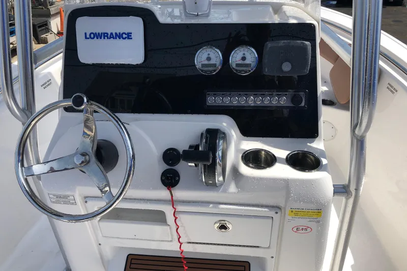 Slide: The Image of Console of a 2018 Tidewater 210 CC Adventure boat with steering wheel and controls. - 1