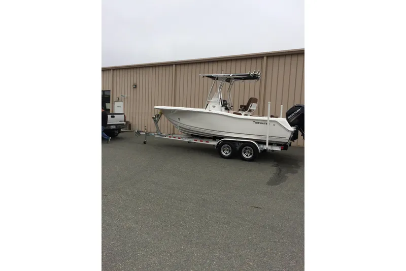 Slide: The Image of 2018 Tidewater 210 CC Adventure boat on trailer, parked beside a building. - 6