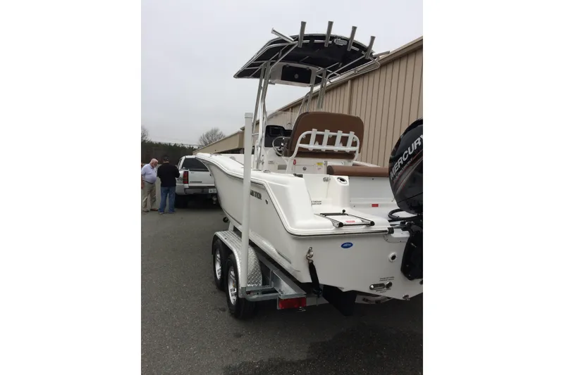 Slide: The Image of 2018 Tidewater 210 CC Adventure boat on trailer, parked near a building. - 7