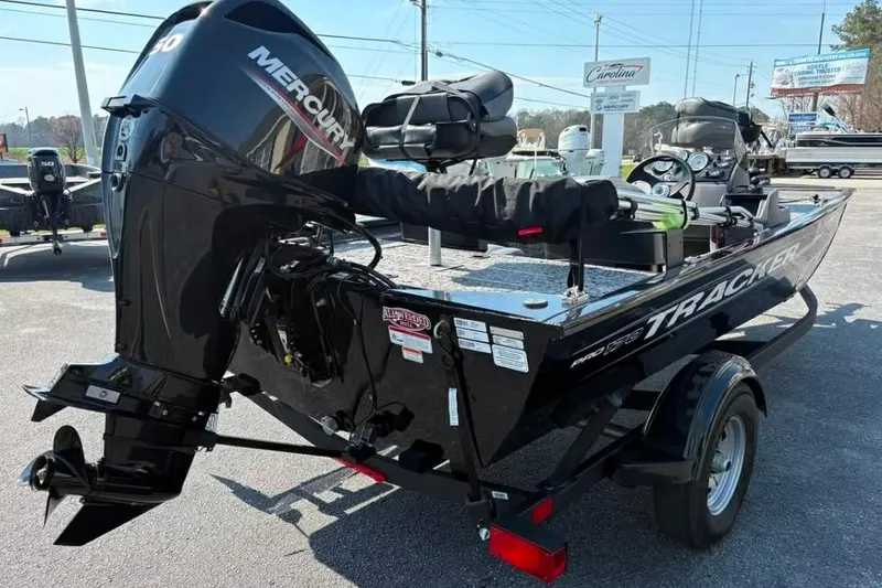 Slide: The Image of 2025 Tracker Pro 170 boat with Mercury engine, parked outdoors on a trailer. - 4