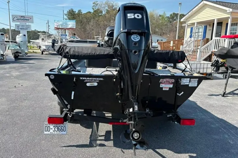 Slide: The Image of 2025 Tracker Pro 170 boat with Mercury 50 engine, parked outdoors. - 5