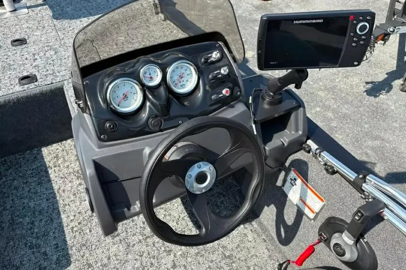 Slide: The Image of 2025 Tracker Pro 170 boat dashboard with gauges and Humminbird fish finder. - 6