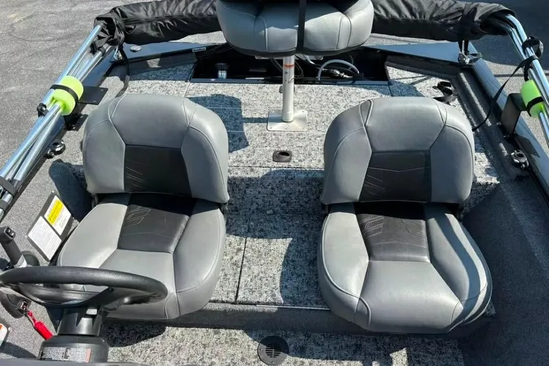 Slide: The Image of 2025 Tracker Pro 170 boat interior with two gray seats and steering wheel. - 8