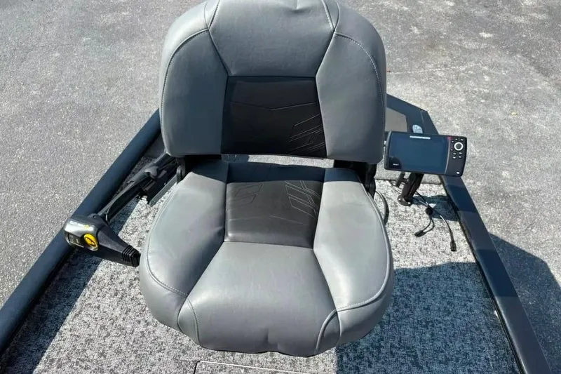 Slide: The Image of 2025 Tracker Pro 170 boat seat with control panel and steering mechanism. - 9