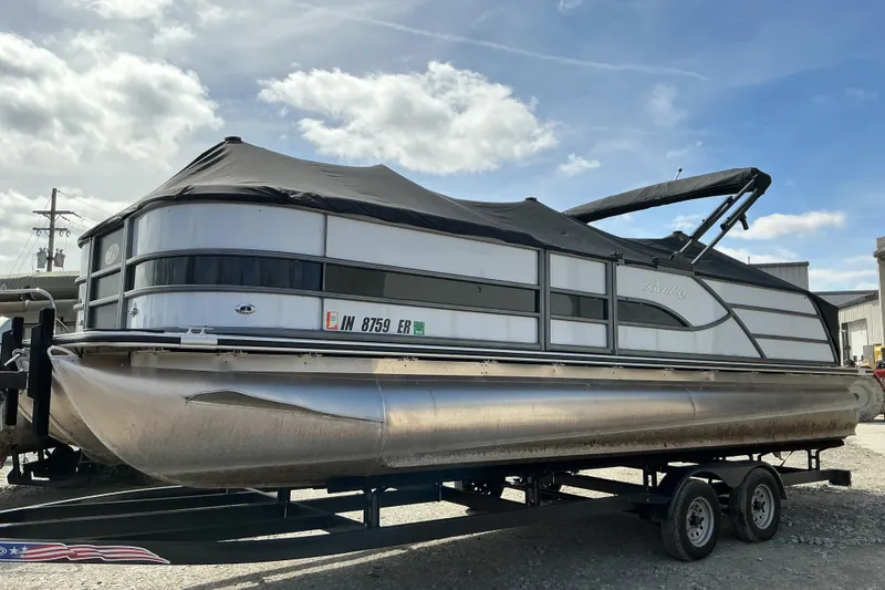 The Image of 2025 Bentley Pontoons Legacy 240 Swingback on trailer under cloudy sky. - 1