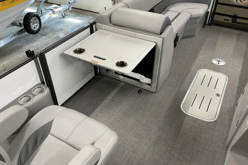 Slide: The Image of 2025 Bentley Pontoons Legacy 240 Swingback interior with seating and fold-out table. - 14