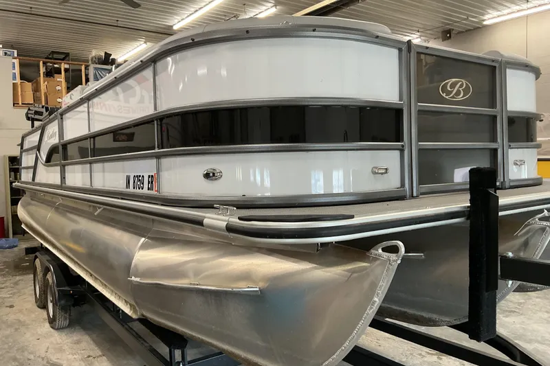 Slide: The Image of 2025 Bentley Pontoons Legacy 240 Swingback in a garage setting. - 4