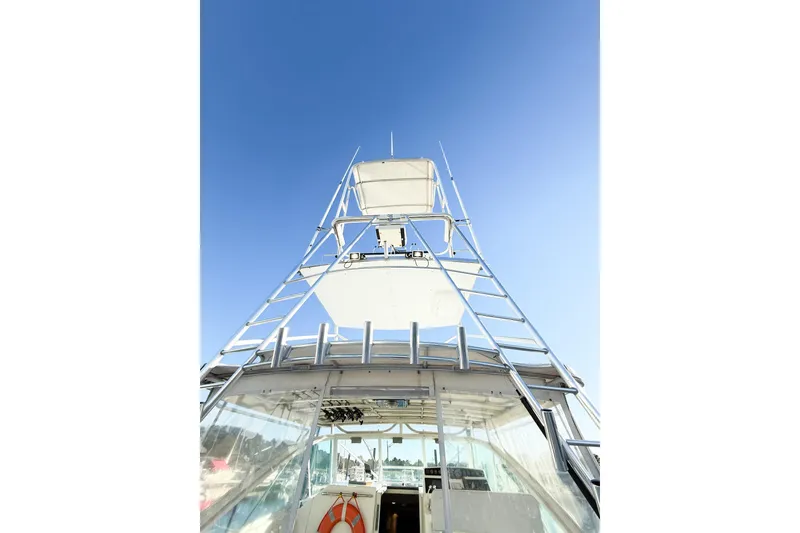 Slide: The Image of 1996 Cabo 35 Express boat tower against clear blue sky. - 10