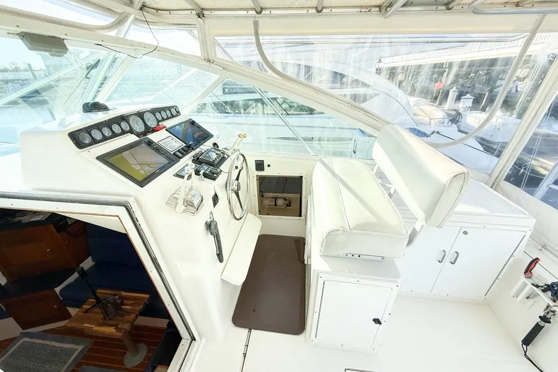 Slide: The Image of Helm of 1996 Cabo 35 Express boat with steering wheel and navigation instruments. - 13