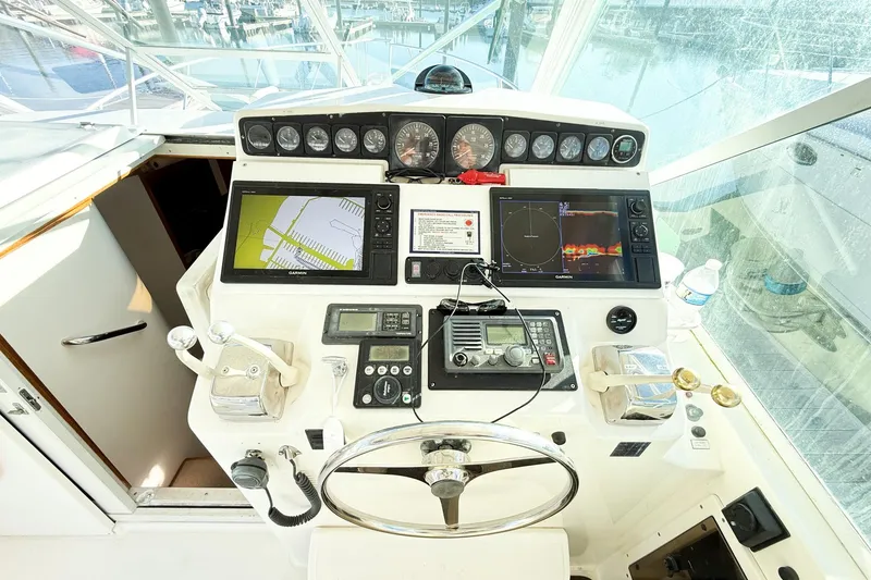 Slide: The Image of Helm of 1996 Cabo 35 Express boat with navigation equipment and controls. - 15