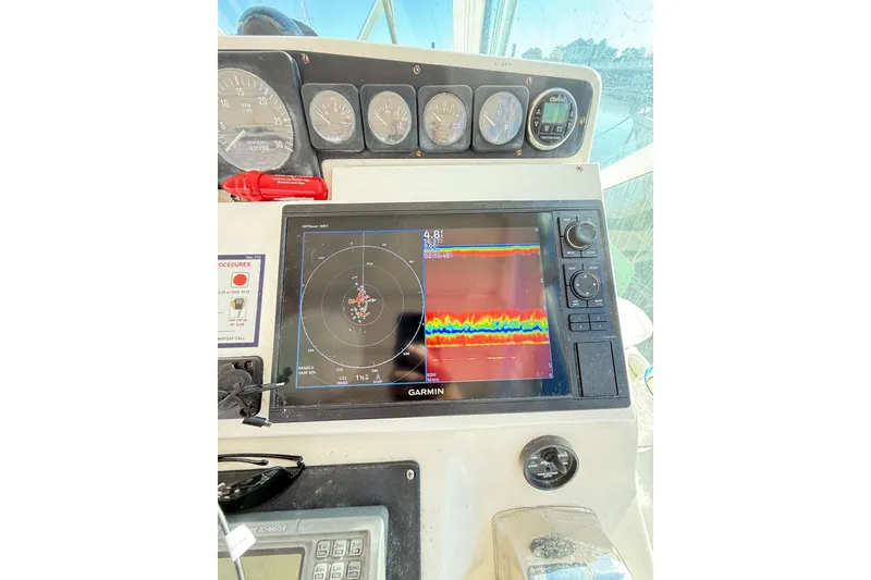 Slide: The Image of Control panel of a 1996 Cabo 35 Express boat with Garmin navigation display. - 17
