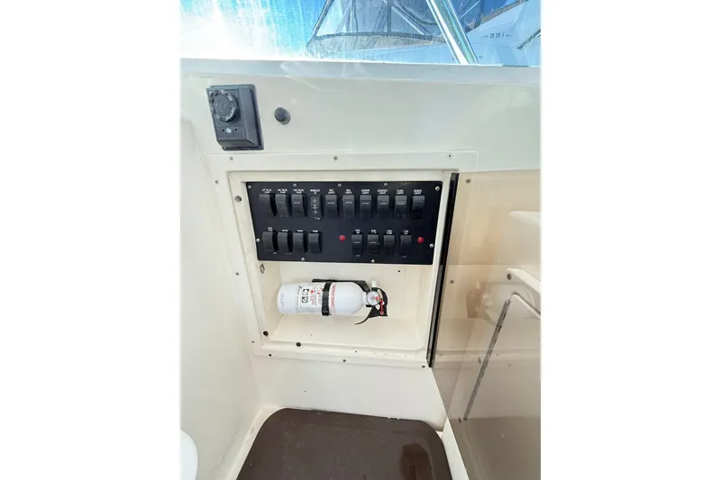 Slide: The Image of Control panel and fire extinguisher on a 1996 Cabo 35 Express boat. - 18