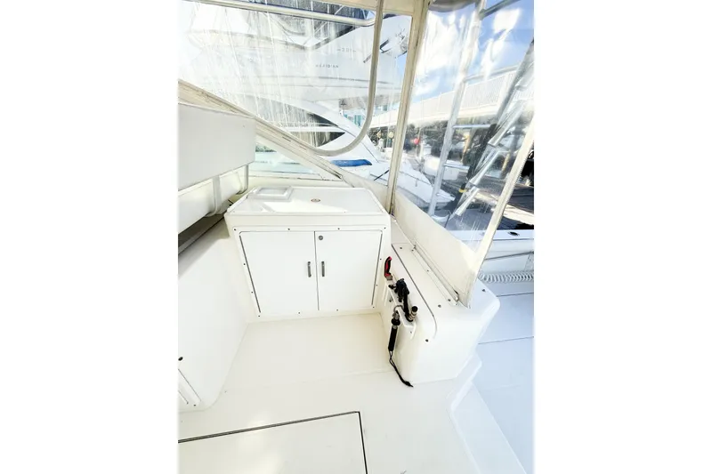 Slide: The Image of 1996 Cabo 35 Express boat interior with white cabinetry and clear windows. - 19