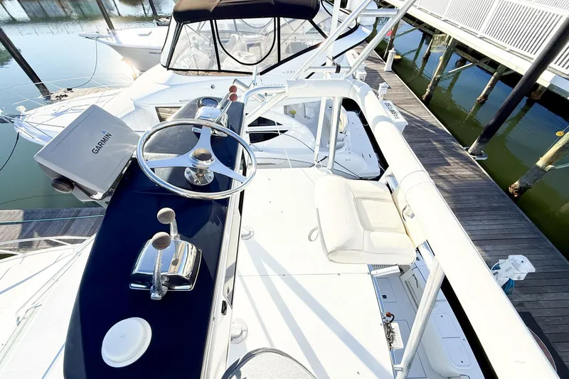 Slide: The Image of 1996 Cabo 35 Express boat helm with Garmin navigation, docked at marina. - 22