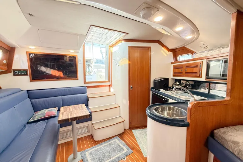 Slide: The Image of Interior of a 1996 Cabo 35 Express yacht with modern amenities and wooden finishes. - 23