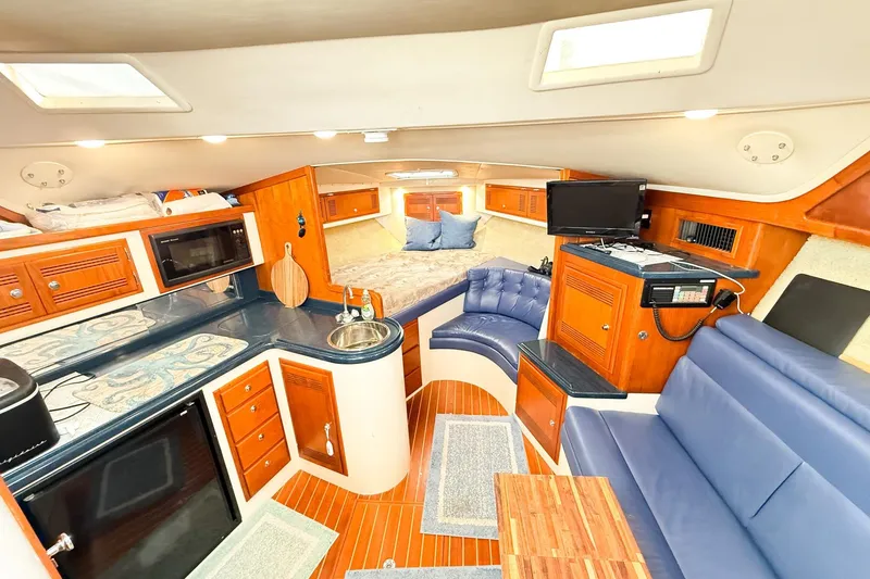 Slide: The Image of Interior of a 1996 Cabo 35 Express yacht with kitchen and seating area. - 24