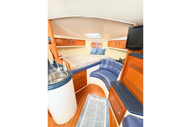Slide: The Image of Interior of a 1996 Cabo 35 Express yacht with cozy seating and modern amenities. - 26