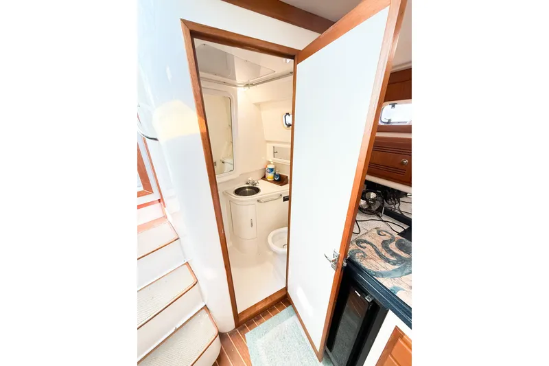 Slide: The Image of 1996 Cabo 35 Express yacht bathroom interior with sink and mirror. - 28